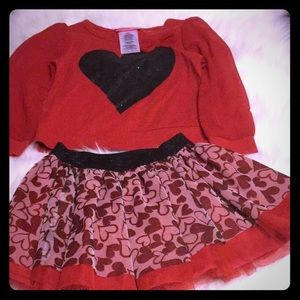 Matching outfit with skirt and long sleeve shirt.